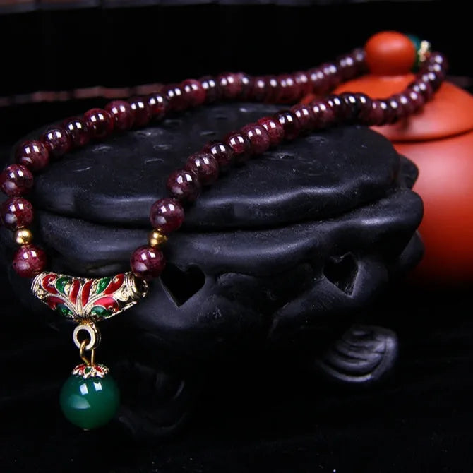 Natural garnet bead bracelet with gold rings and golden toad charm on adjustable cord
