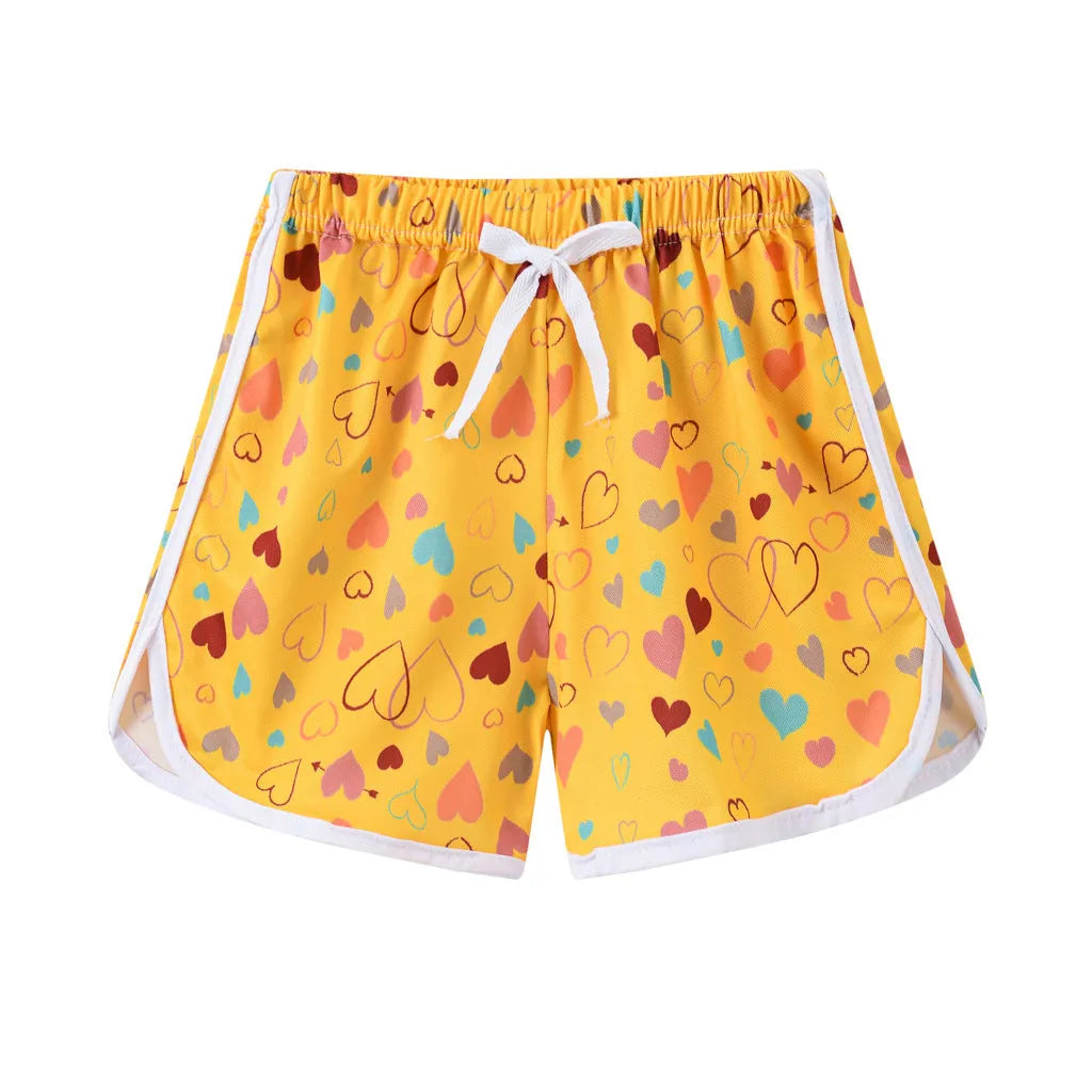 Children's colourful polyester beach shorts showing patterns like leopard print, stripes, and pineapples.
