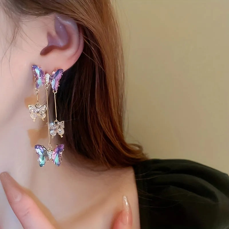 Blue purple butterfly tassel earrings with silver crystal flowers on alloy settings.