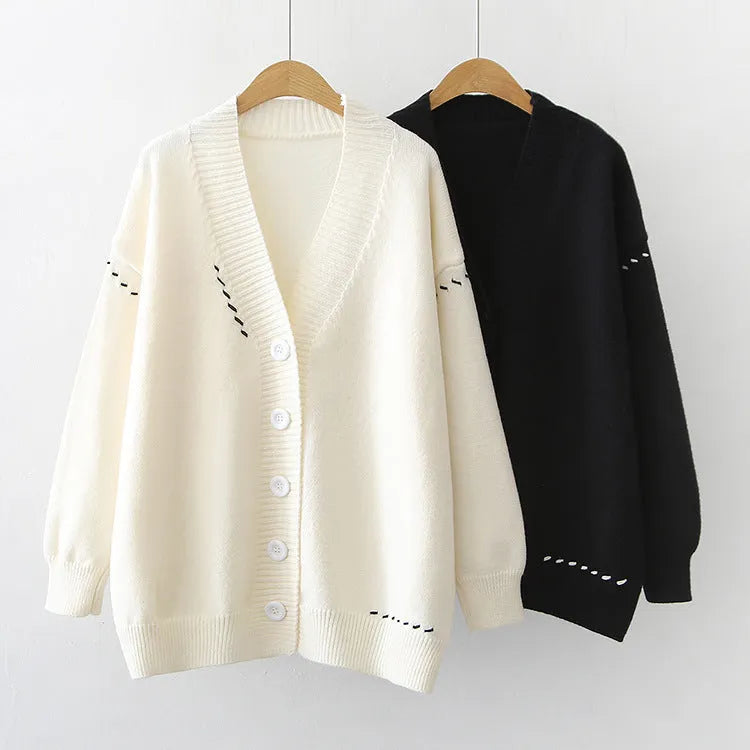 A loose-fitting black women's knitted cardigan top coat with long sleeves.