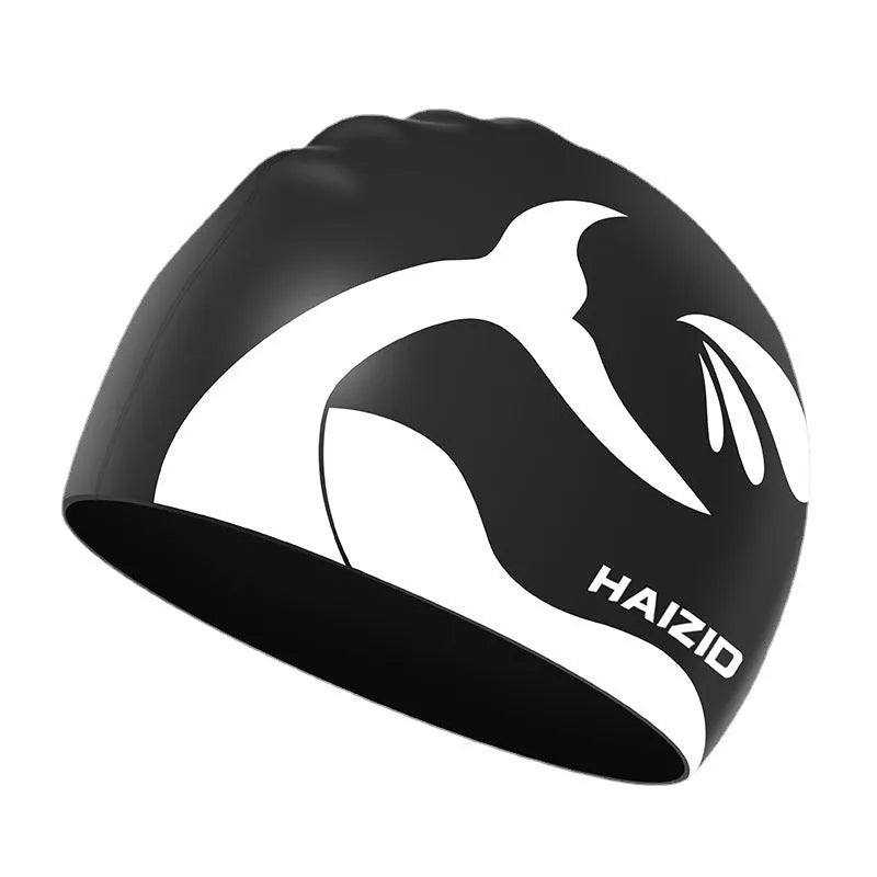 Silicone swim cap with whale tail pattern and built-in ear protectors in assorted colours.