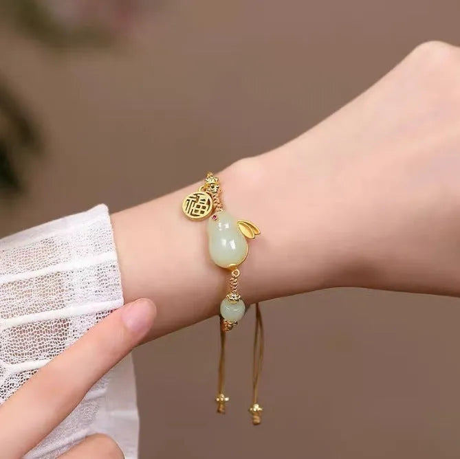 Yellow string bracelet with a geometric Hetian jade charm shaped like a rabbit for women.