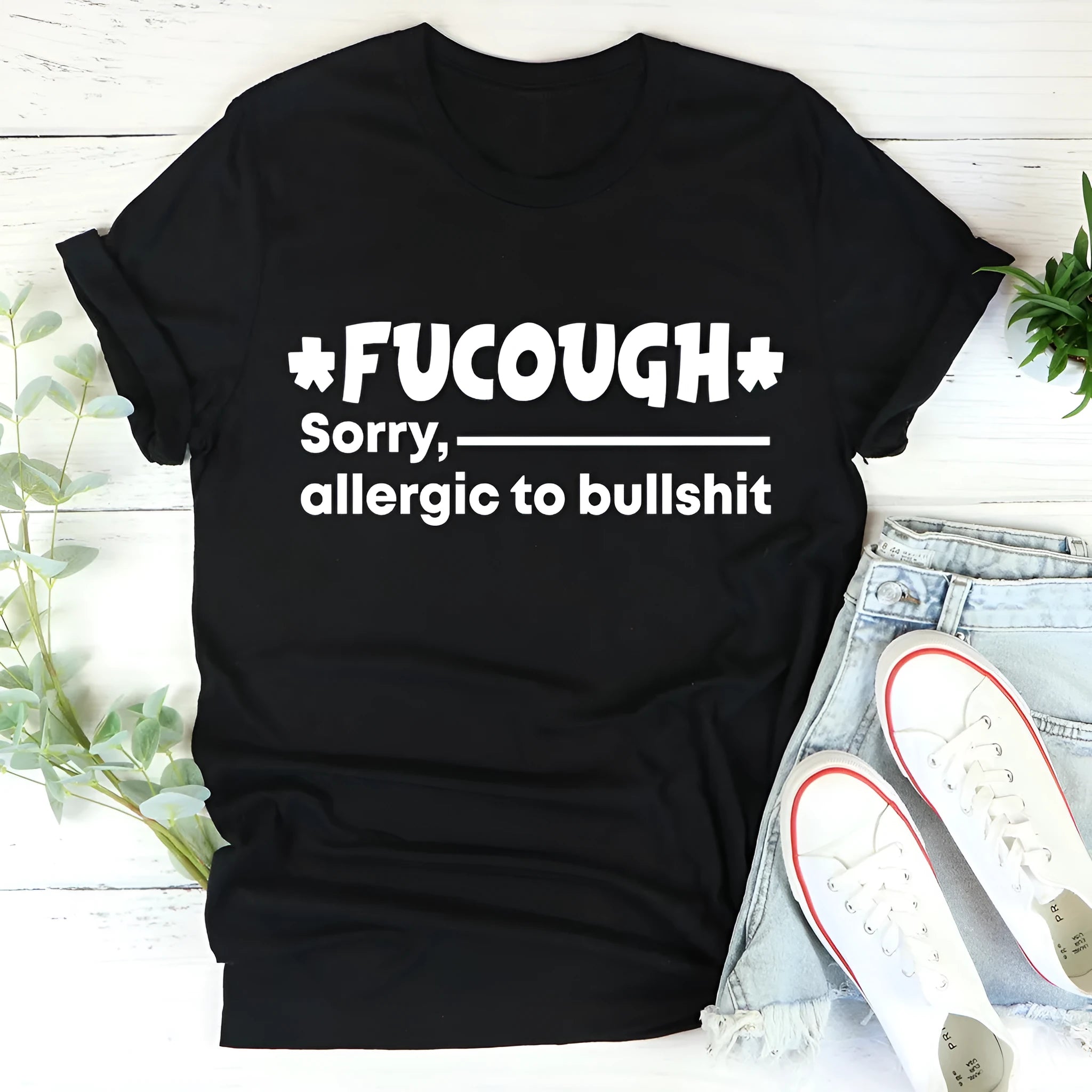 Black loose-fit cotton t-shirt with short sleeves and a round neck on a hanger.