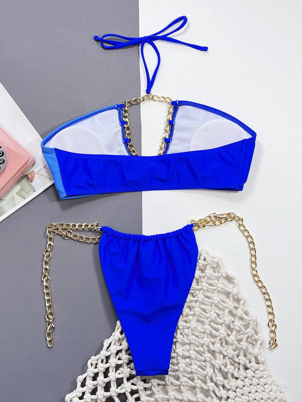 Blue solid colour women's bikini swimsuit with split style design on mannequin