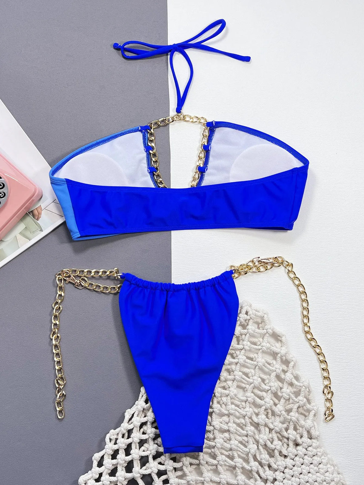 Blue solid colour women's bikini swimsuit with split style design on mannequin