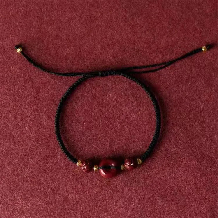 Cinnabar heart-shaped safety buckle bracelet with adjustable knot closure on wrist