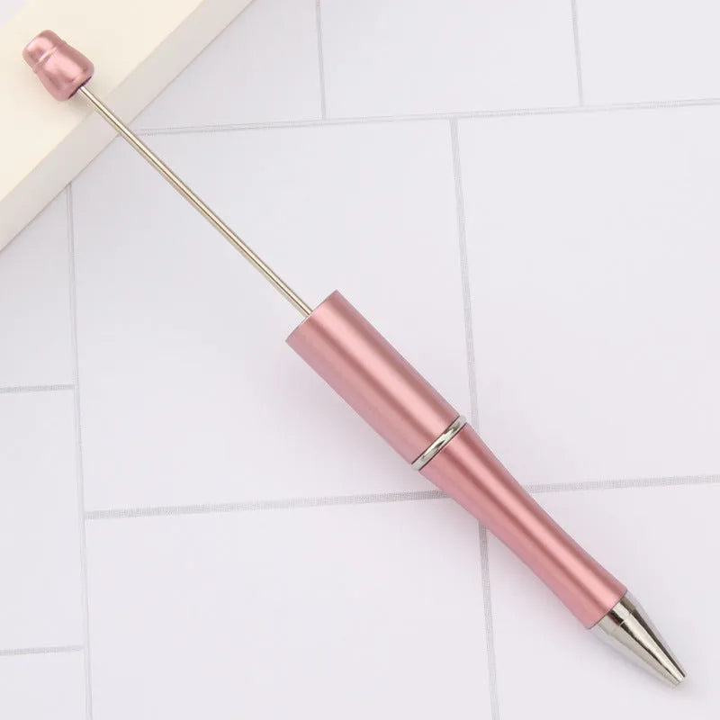 Ballpoint pen with colourful spinning plastic beads on barrel, shown in a gradient purple finish.