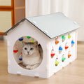 Plastic cat scratch board and bed integrated toy with a built-in tunnel containing a bell ball.