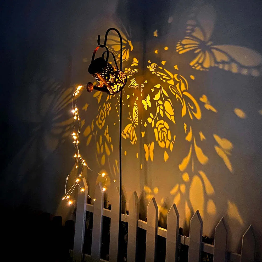 Tapered iron solar garden lamp with butterfly pattern emitting warm white light in a courtyard setting