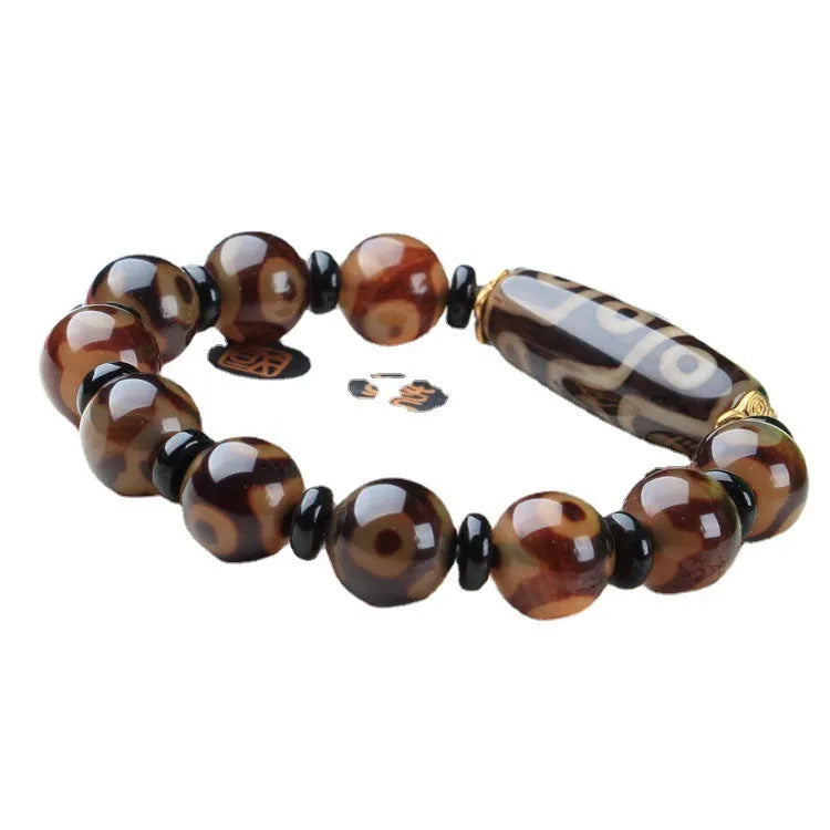 Distressed agate bracelet with traditional Tibetan dzi beads including three-eye and Nine Eyes designs.