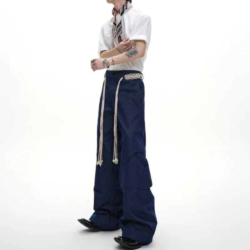 Men's dark blue loose straight-leg jeans with tassel decoration and front zipper placket.