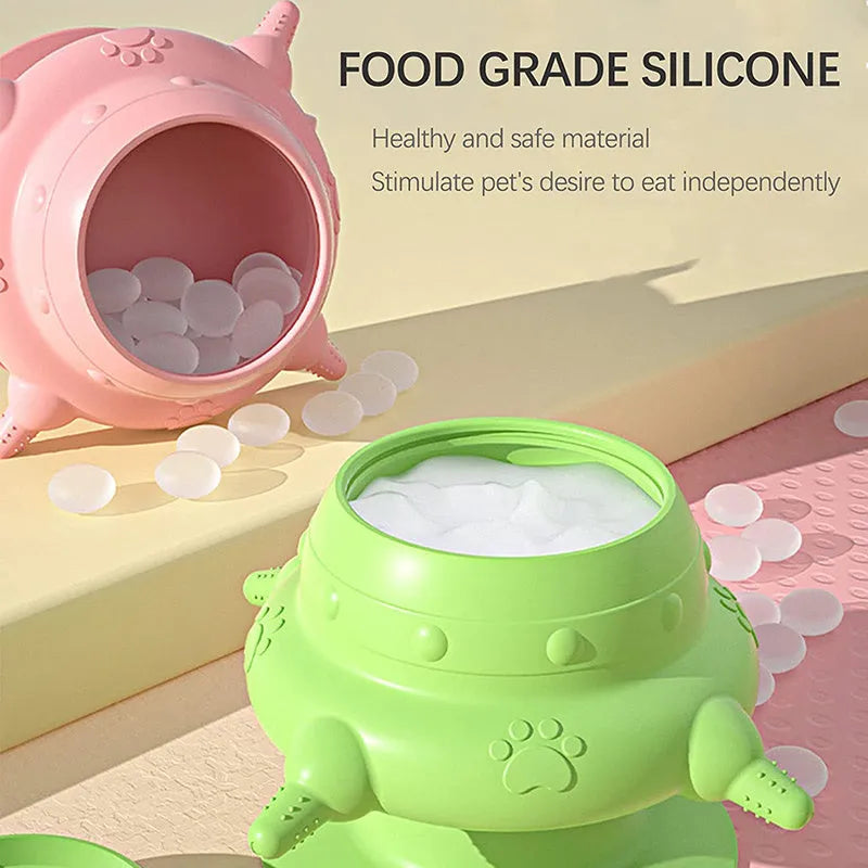 Pink silicone pet nursing device with milk bowl and four pacifiers for puppies and kittens on a flat base.