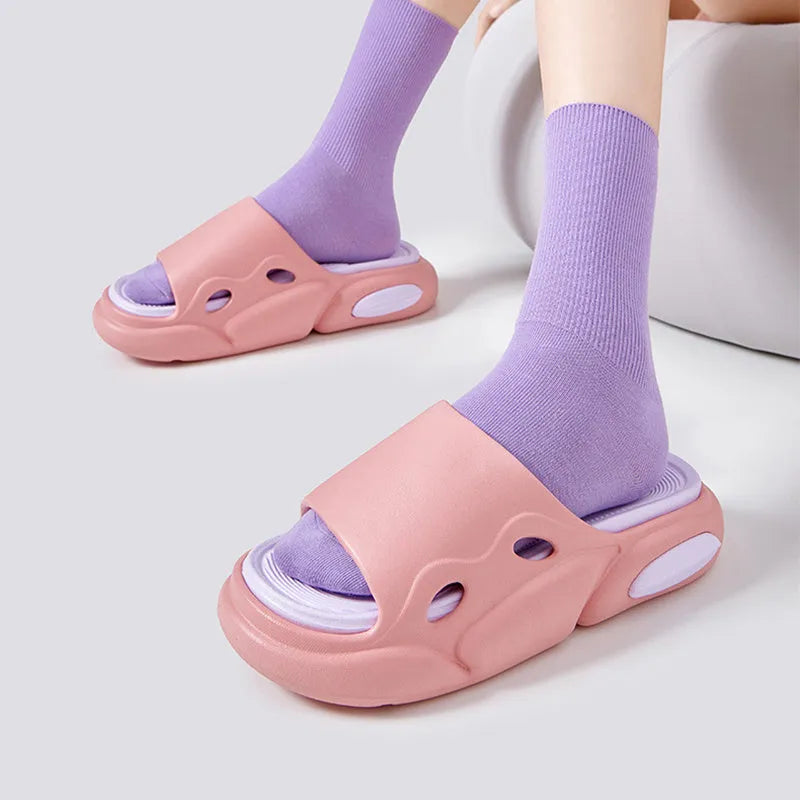 Women's two-colour EVA foam slippers with thick sole in pink and purple, shown on a foot.