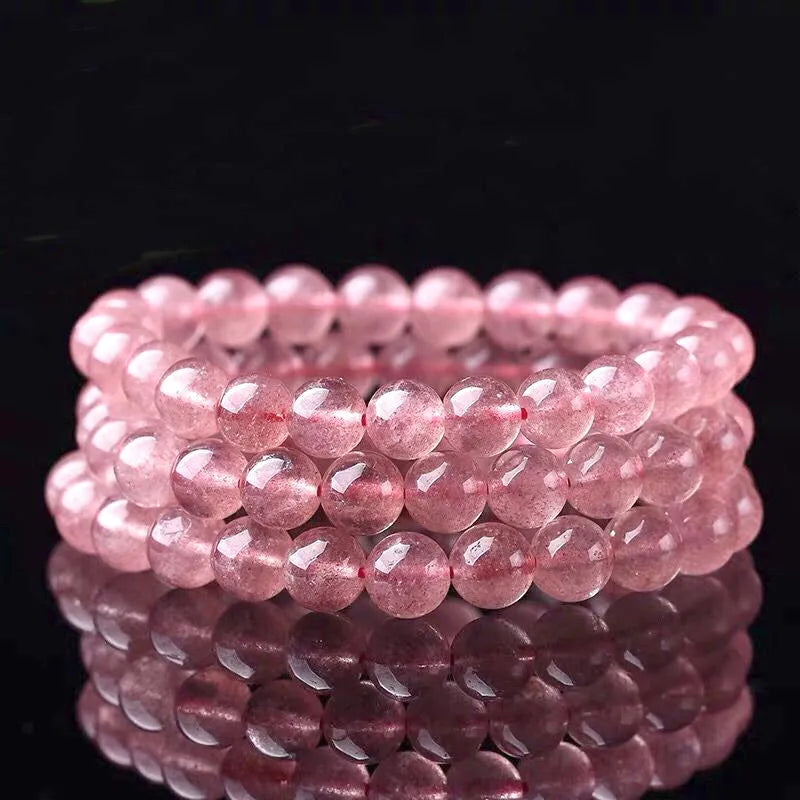 Women's strawberry quartz crystal bracelet with polished beads in 6mm, 8mm, or 10mm sizes