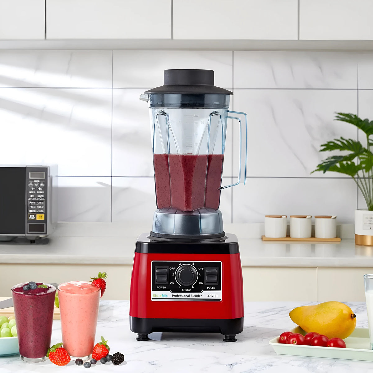 Red commercial blender with stainless steel jug, model A8700, on a countertop.