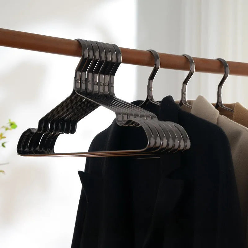 Elegant black metal clothes hanger with anti-slip and anti-rust coating on a white background.