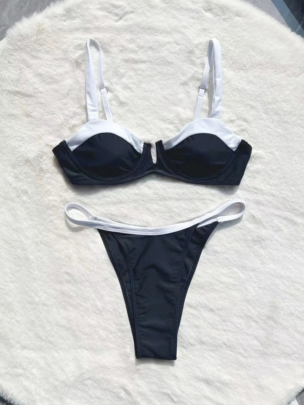 Black low waist women's bikini swimsuit with stitching detail and split design