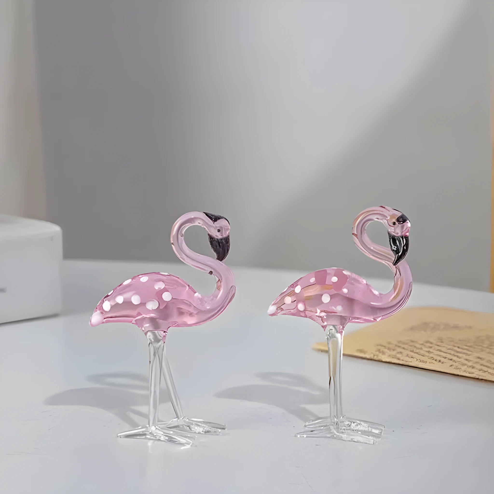 Pink and white crystal decorative flamingo table prop on a modern shelf