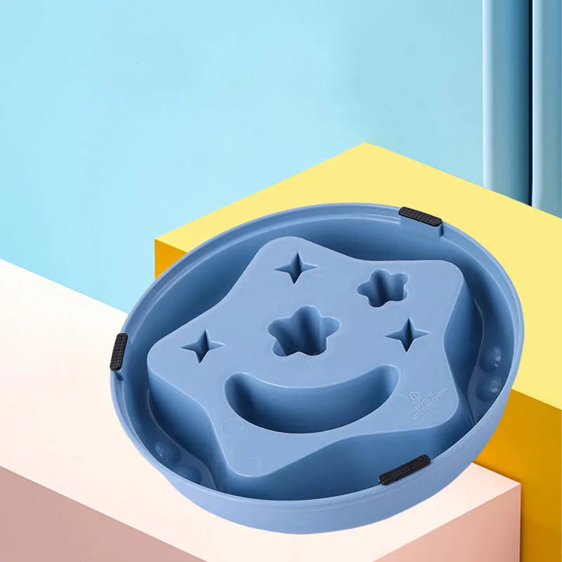 Blue plastic slow feeder dog bowl with moon, star, and wing-shaped interior ridges