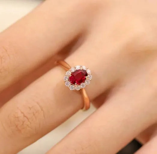 Women's sterling silver ring with gold pigeon design and red gemstone inlay on floral patterned band