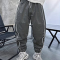 Men's loose-fit cropped sports trousers in bamboo fibre, shown in khaki colour.