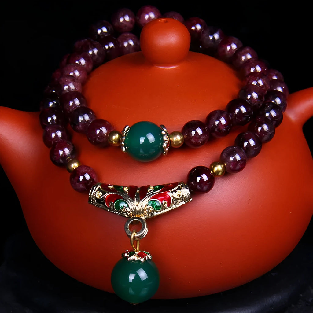 Natural garnet bead bracelet with gold rings and golden toad charm on adjustable cord