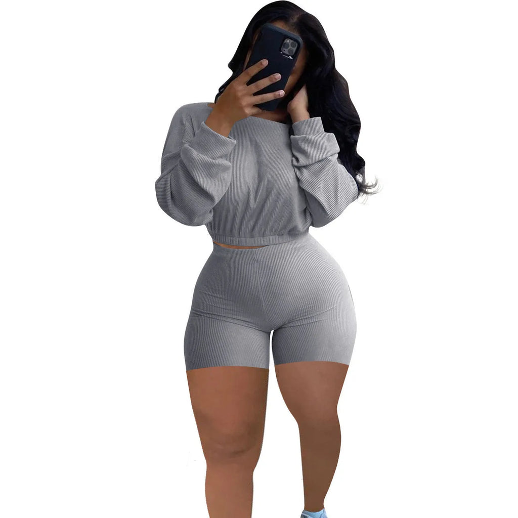 Women's solid colour off-the-shoulder long sleeve top and matching shorts two-piece set.