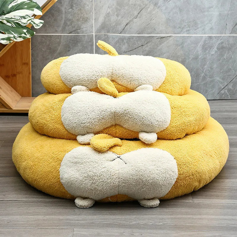 Brown and white corgi-shaped plush dog bed on a wooden floor.