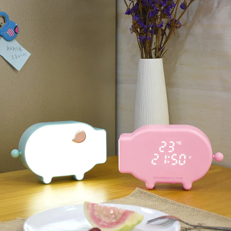 Blue multifunctional LED alarm clock displaying time and temperature on bedside table with USB cable.