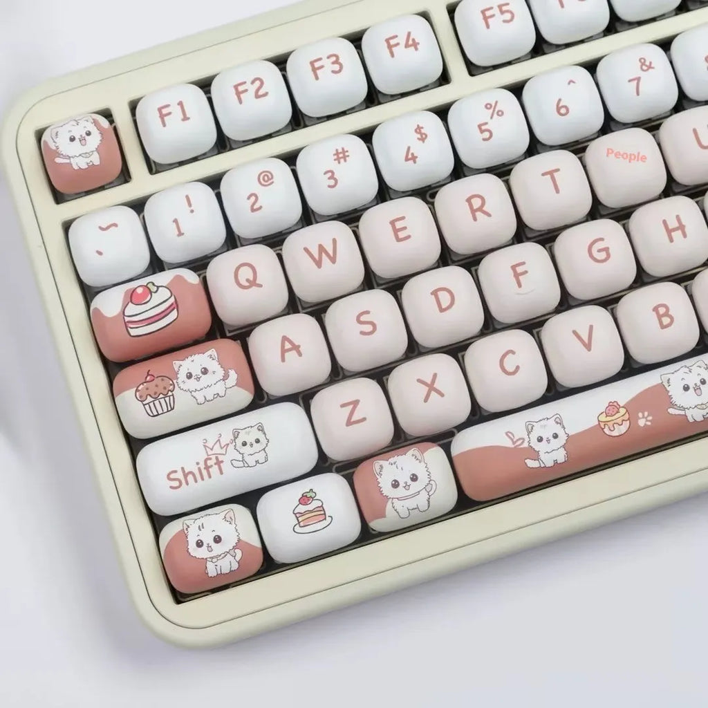 A single round MOG profile key cap with a sublimation printed cartoon dessert cat illustration.