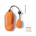 Suede car key cover in cement grey, dark green, light grey, and orange colour options