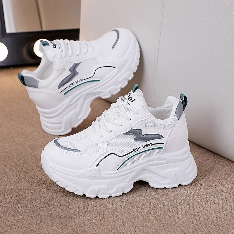 White women's dad shoes with cross shoulder straps and a round toe, shown on a foot.