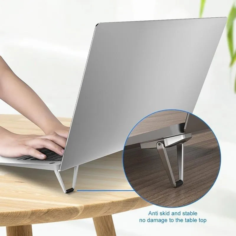 Aluminum alloy foldable laptop bracket shown in silver colour beside measuring tape showing 4.8cm width