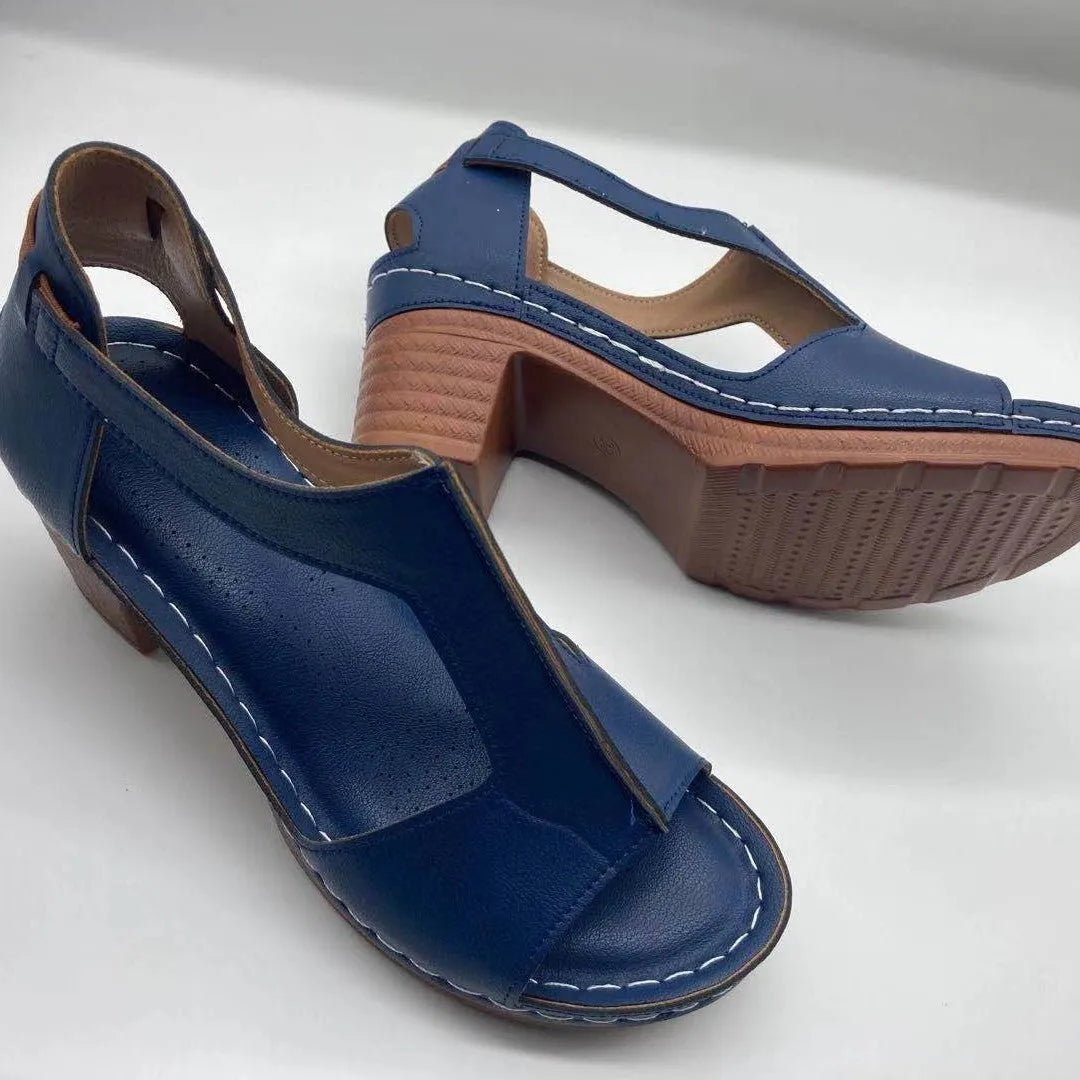 Women's peep toe wedge sandals with Roman-style buckle on a low heel.