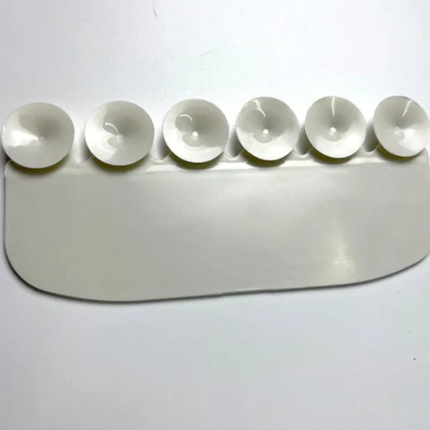 White PVC urine blocking board for children's toilet training placed around toilet bowl