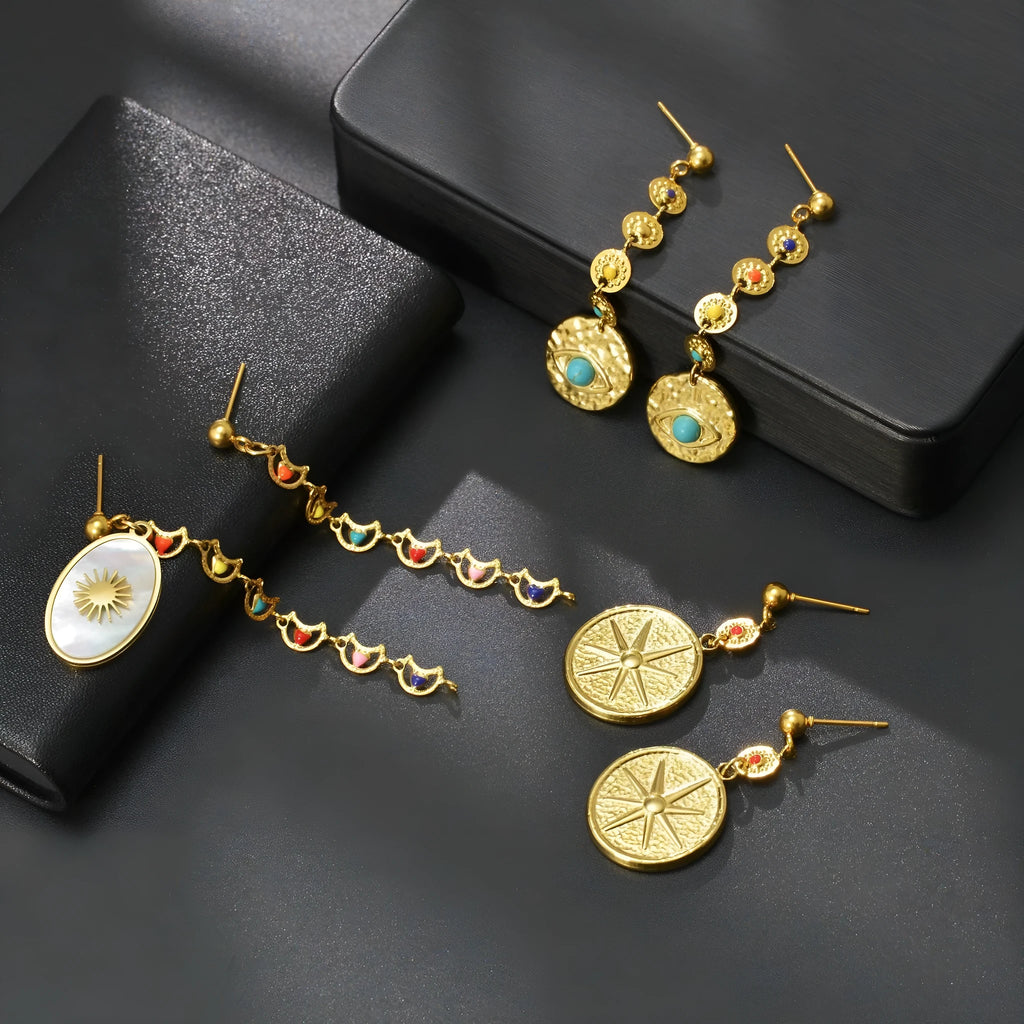 Stainless steel geometric earrings showing eight-awn star, eye and shell sun pattern options