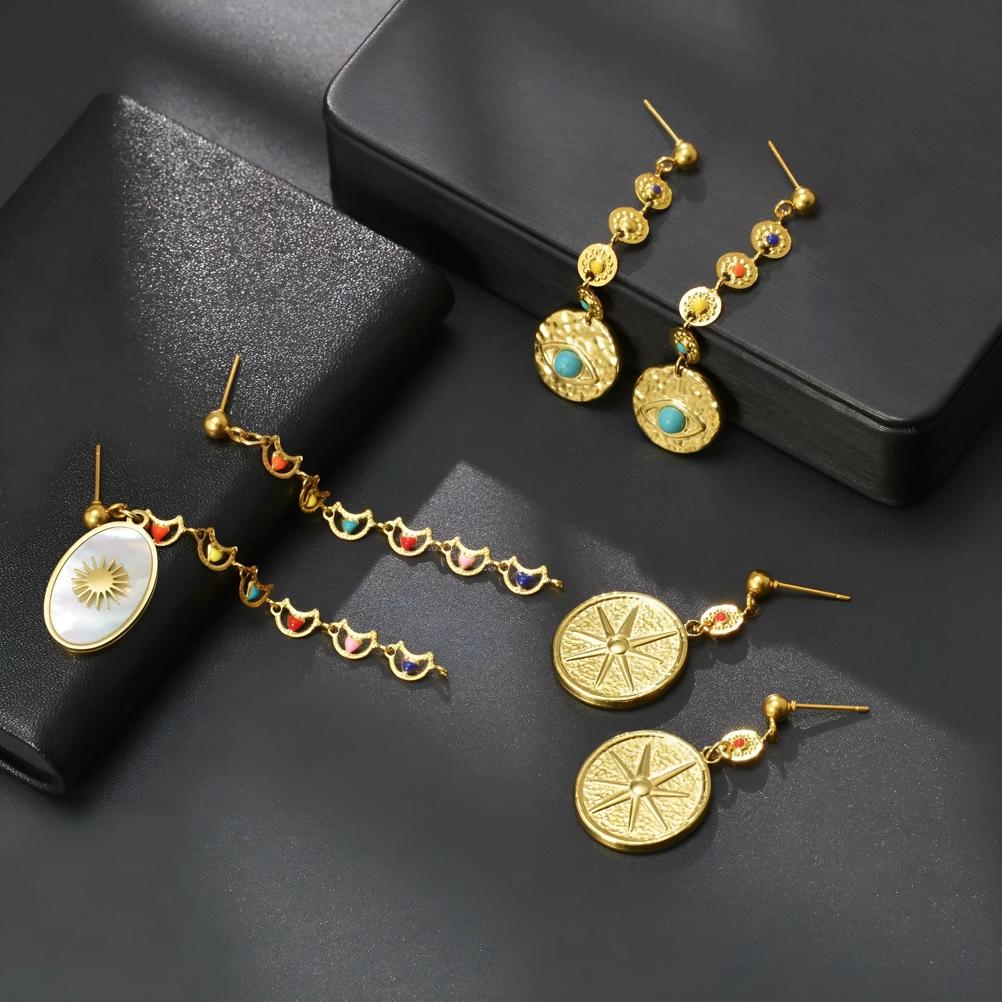 Stainless steel geometric earrings showing eight-awn star, eye and shell sun pattern options