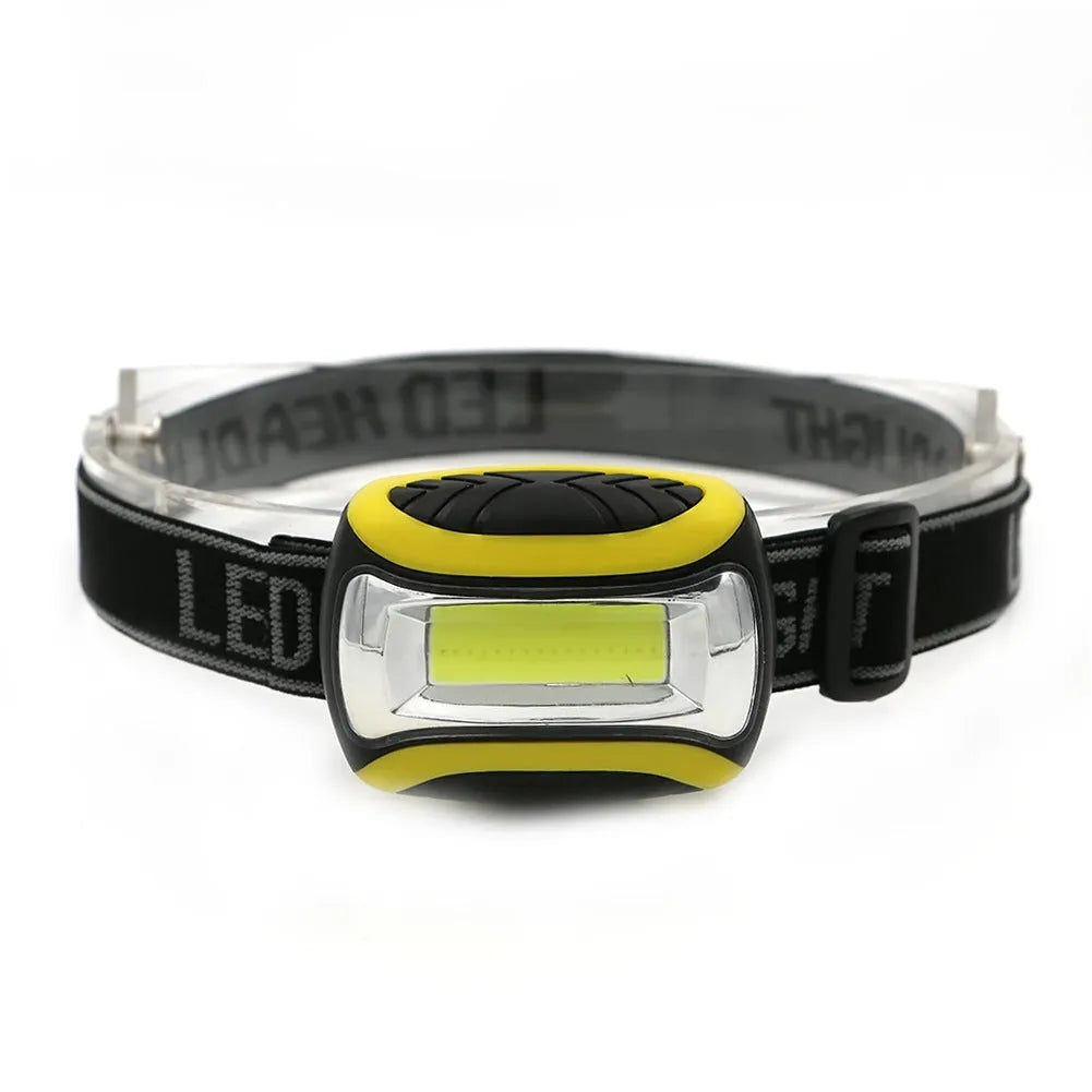 Yellow plastic headlamp with a central COB LED light, shown as a single unit for outdoor use.