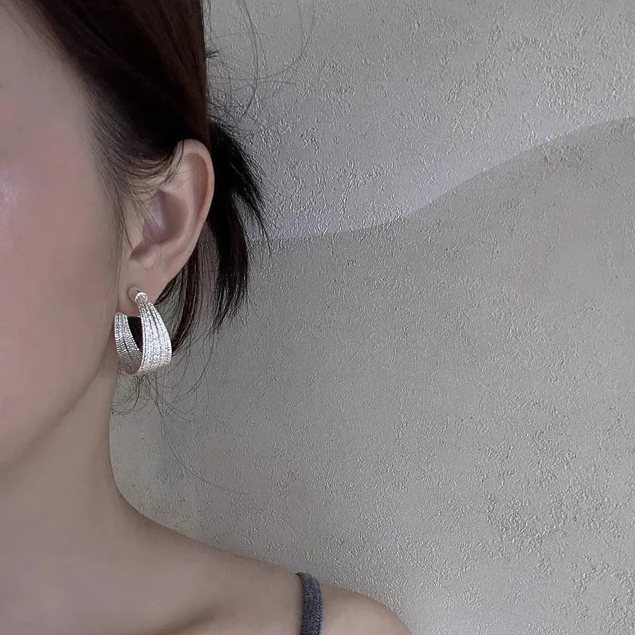 Geometric copper earrings in silver and gold finishes as clip-on and stud styles