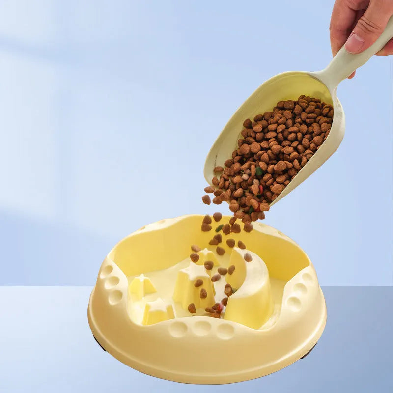 Blue plastic slow feeder dog bowl with moon, star, and wing-shaped interior ridges