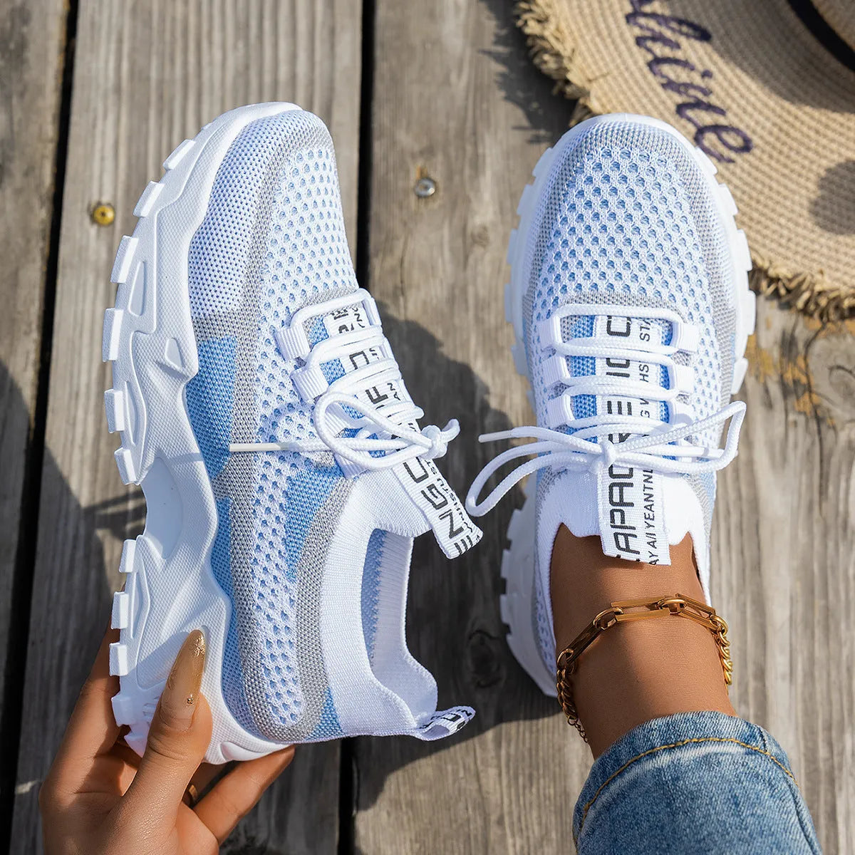 Women's flyknit mesh sneakers with rubber sole and lace-up design in black and gray