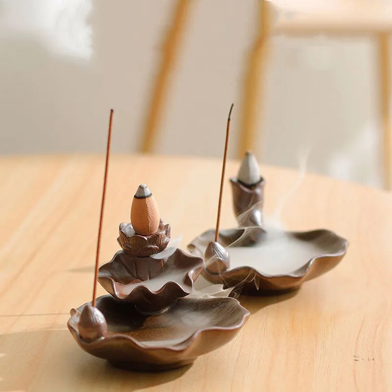 Ceramic reverse flow incense burner with purple clay construction and traditional good luck decorative motifs
