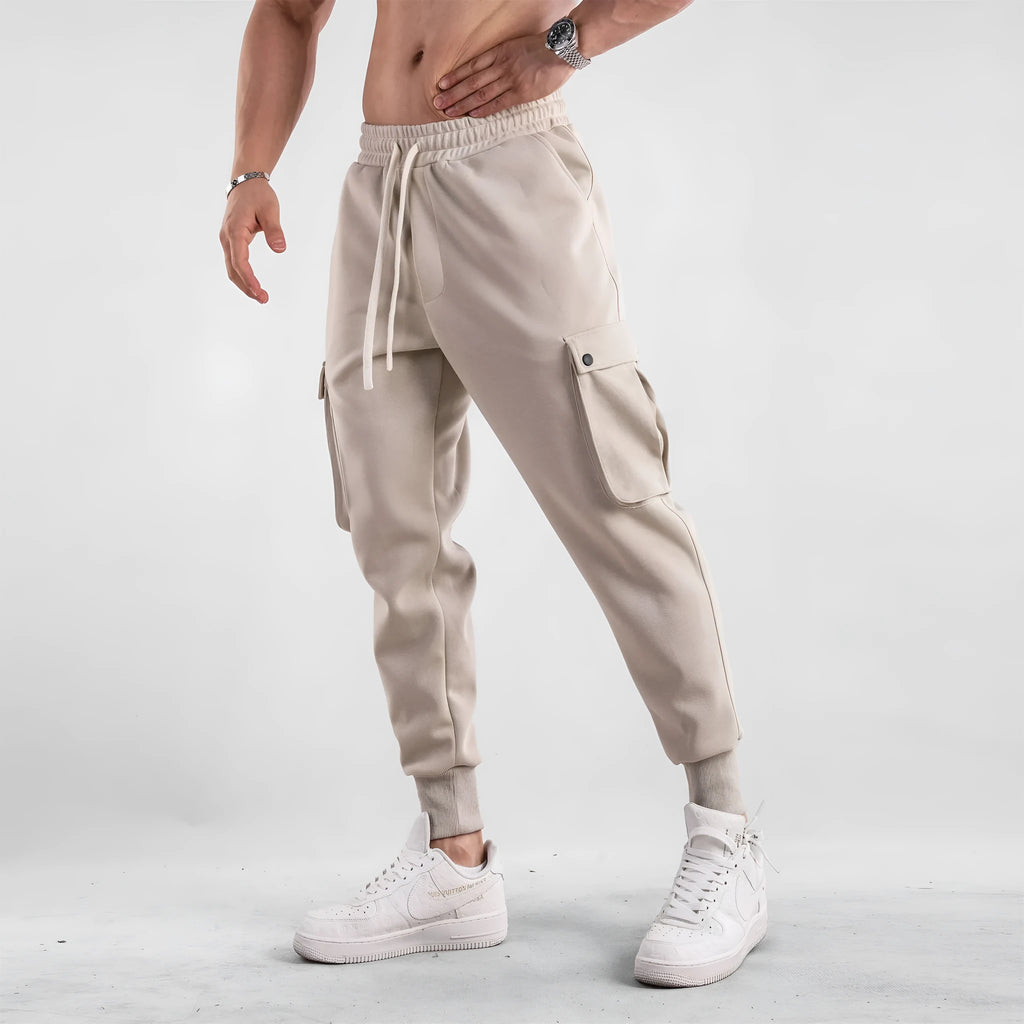 Men's loose cotton sports trousers with ankle tie closure and multiple pockets in solid colour