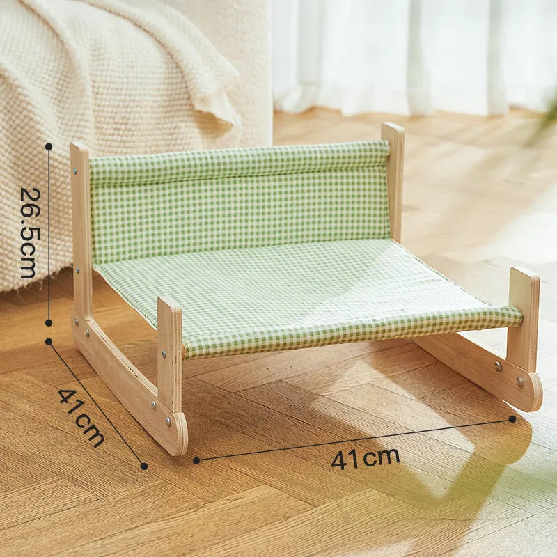 Wooden elevated cat bed with blue cloth hammock for indoor feline lounging