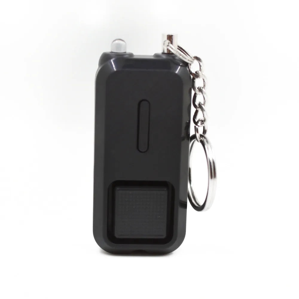 Compact pink personal safety alarm for women with keychain, shown next to its white box.