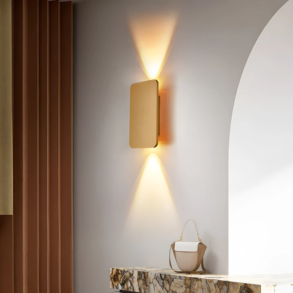 Minimalist modern wall lamp with a slim metal frame in a choice of four finishes, mounted on a wall.