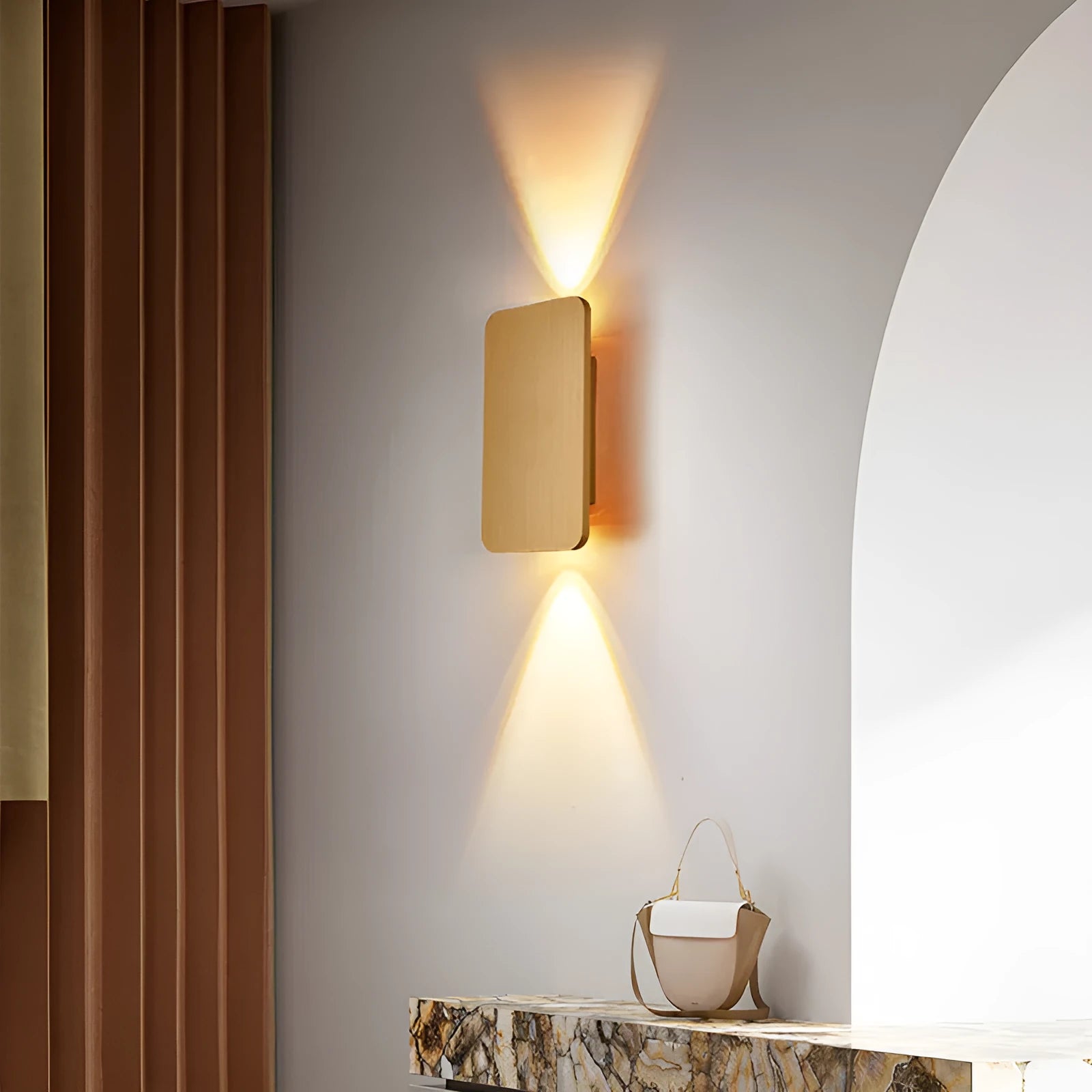 Minimalist modern wall lamp with a slim metal frame in a choice of four finishes, mounted on a wall.