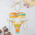 Women's green striped halter neck bikini swimsuit with matching briefs on a mannequin