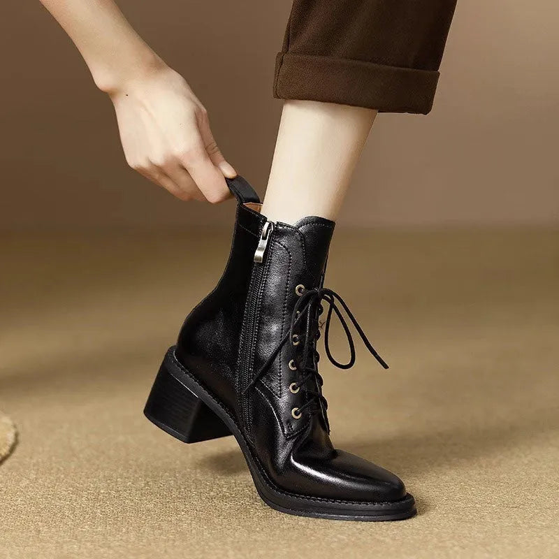 Women's black pointed toe short tube boots with 5.5cm heel on wooden floor