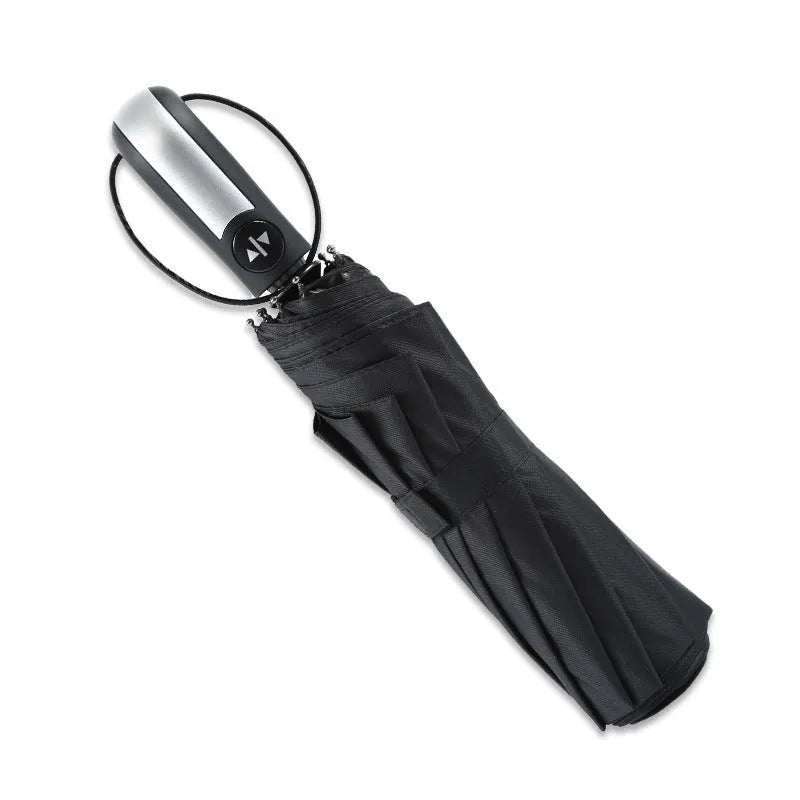 Triple-fold black automatic business umbrella with steel frame and rubber handle open.
